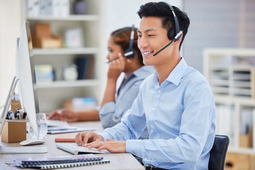 Business man, telemarketing and call center consultation in a office working on a computer. Smile, male worker and web support advice of a contact us employee with professional communication at job.