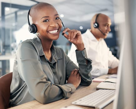 Consultant, woman call center agent with headset and computer for online communication at office. Customer service or crm , telemarketing or consulting and African female smile at her workstation.