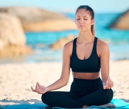 Yoga, calm and meditate on the beach with zen on a mat for wellness in cape town for workout. Ocean, balance and yogi with peace with lotus in summer for fitness with mental health and freedom