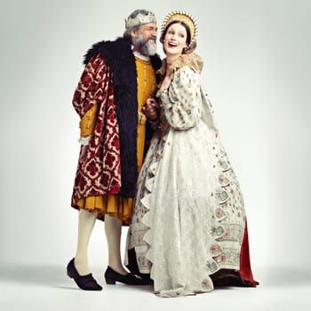 King, queen and love in medieval costume for royal party, retro carnival and theatre fashion clothes in white background. Couple, happy face and talking in vintage renaissance isolated in studio.