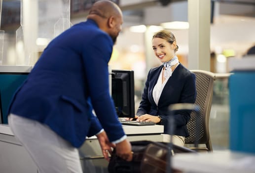 Black man, airport reception and security check with woman, concierge and help desk in lobby with luggage. African businessman, travel and immigration at inspection for international transportation.