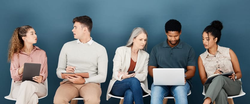 Laptop, phone and business people waiting for job interview, vacancy and career opportunity in office. Technology, diversity and men and women candidates for hr meeting, recruitment and employment.