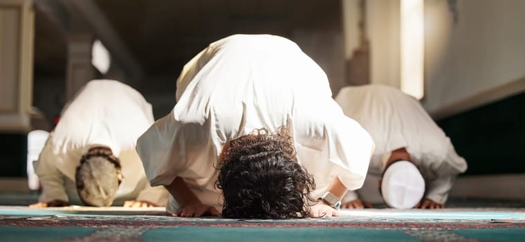 Muslim, prayer and mosque with a spiritual man group praying in faith during fajr, dhuhr or asr, otherwise maghrib or ishaa. Salah, worship and pray with islam men at ramadan for holy tradition.