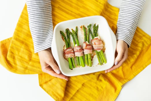 Asparagus baked with bacon and spices. Very tasty and healthy food. Serving food by the chef. View from above