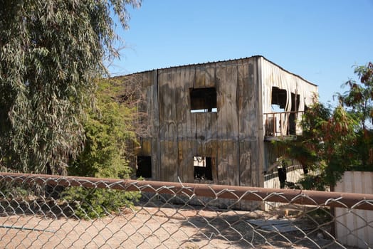 Abandoned building with metal walls street view . High quality photo