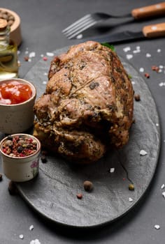 Baked pork collar with spices on a wooden board, delicious and juicy meat