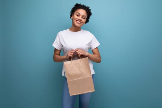 young latin brunette woman works in a delivery service and distributes paper bags.