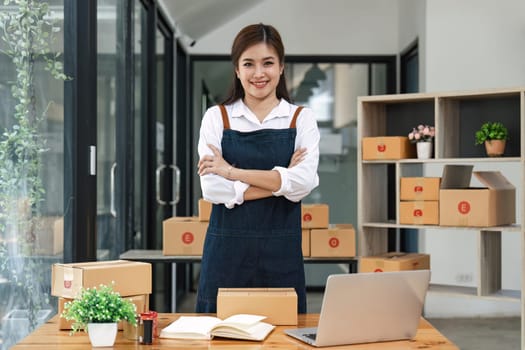 Happy asian woman work from home packaging, on line marketing packaging and delivery, SME concept.