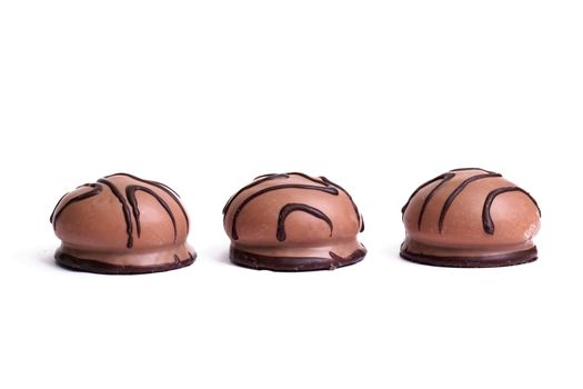 Three cookies in chocolate isolated on a white background