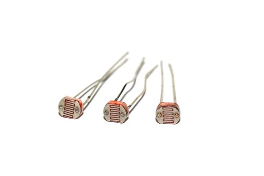 Three photoresistors isolated on a white background close up