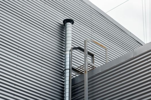 Hood pipe on the wall of an industrial building close up