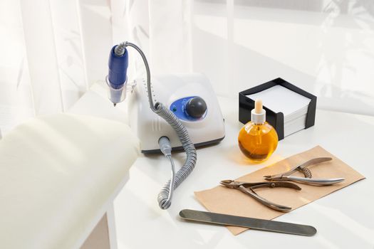 Manicure equipment. Set for home manicure and nail care. Manicure or pedicure set tools are placed on a table with a white towel in the beauty salon. Equipment for beauty shop or beauty parlour