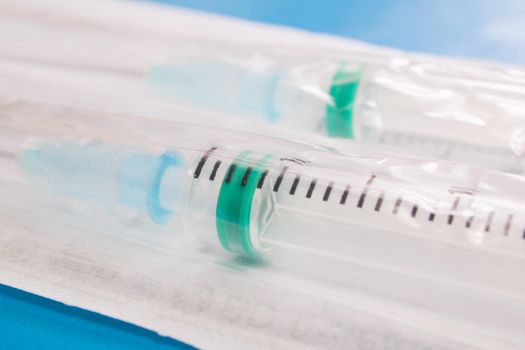 Syringes in a package on a blue background