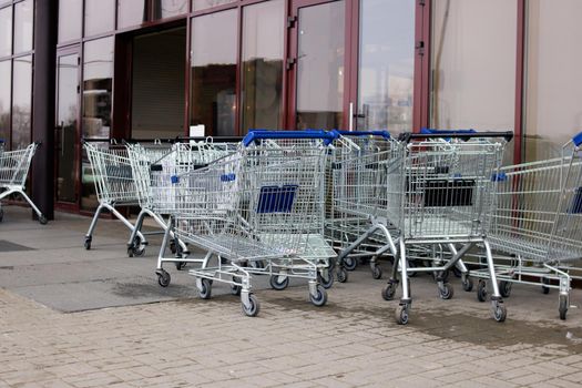 Many shopping carts at the entrance to the store