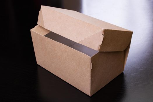 Cardboard box on a wooden table close up
