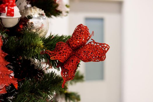 Red and white toys on the Christmas tree close up