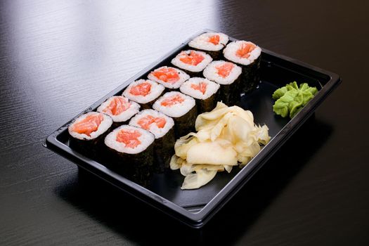 Rolls with salmon in a container closeup