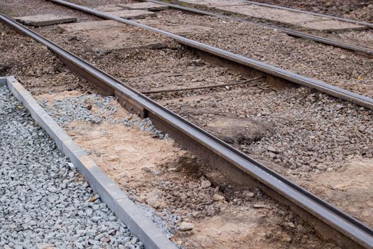 Sand on repair work on tram rails close up