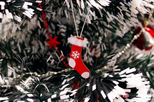 Red christmas decoration on a spruce branch close up