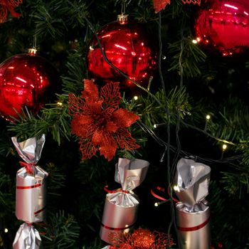 Red and white toys on the Christmas tree close up