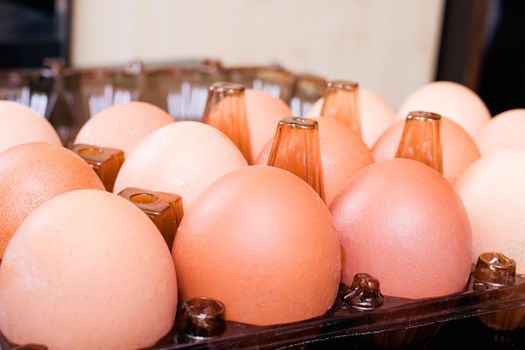 Many chicken eggs in a box top view