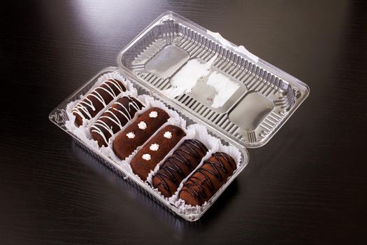 Chocolate cakes with cream close up on wooden table