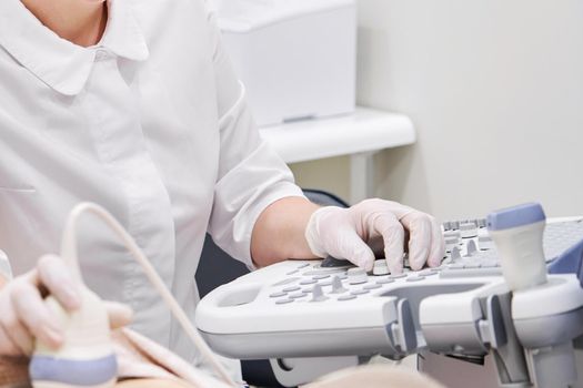 Young woman undergoing ultrasound scan in modern clinic