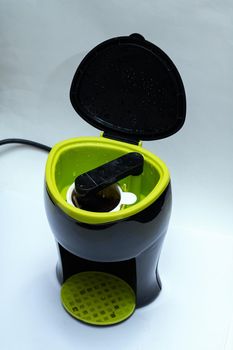 Black electric coffee maker on a gray background
