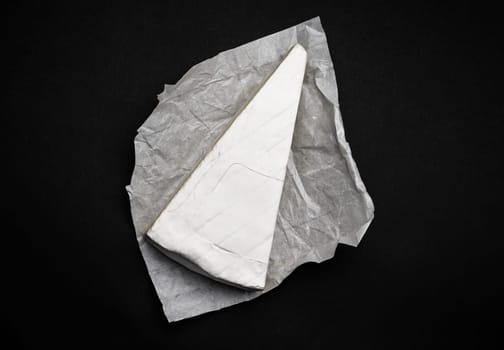 Creame cheese brie on black background. French delicatessen for gourment and healthy nutrition