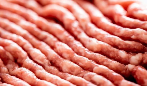 Raw red ground meat fresh with protein closeup. Uncooked beef hamburger ingredient for meatballs closeup