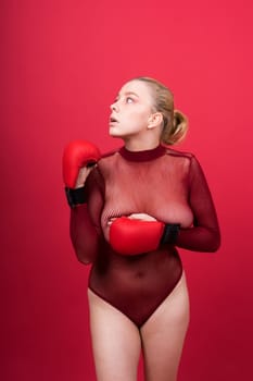 Boxer, seductive confident female boxer with gloves studio, sporty woman posing looking to camera.