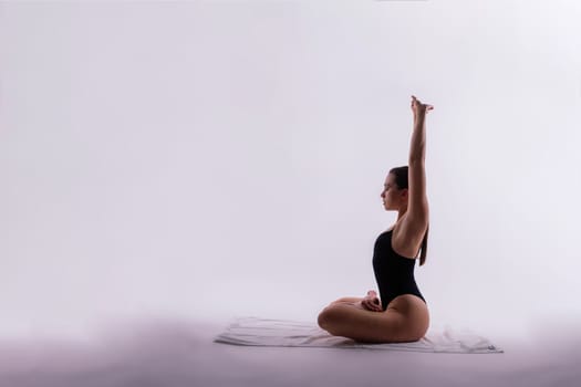 Image of a young plump female doing acrobatic stunt, studio shot