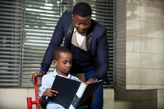 Family relationship between father and son. father or businessman teaches his child out of outdoor offices. Learning concept. Concept of relationships and people.