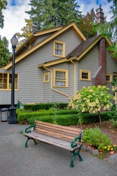 Historical residential house with wooden bench in front.