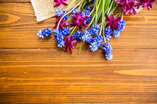 beautiful bouquet of spring flowers on a wooden table, rustic style.