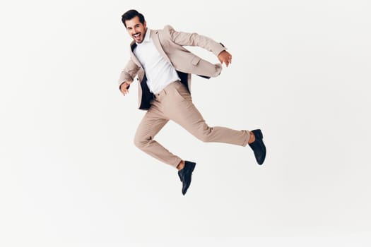 portrait man model victory suit copyspace arm jumping beige smiling shirt running happy up smile occupation sexy business cheerful businessman winner