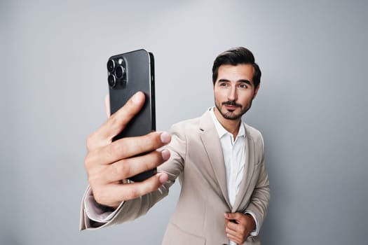 man blogger hold gray internet suit happy corporate smile white connection young business phone portrait selfies lifestyle guy smartphone cellphone call