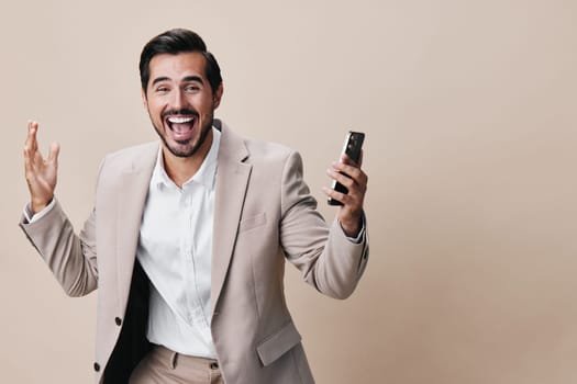 internet man corporate online copy background smile phone smartphone white hold studio success suit space handsome happy person call beige business portrait