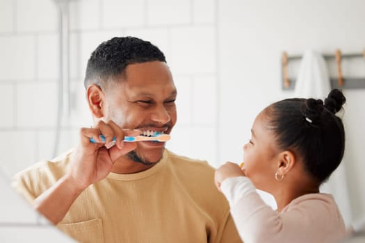 Father, child and brushing teeth in a family home bathroom for dental health and wellness in a mirror. Happy african man and girl kid learning to clean mouth with a toothbrush for oral hygiene.