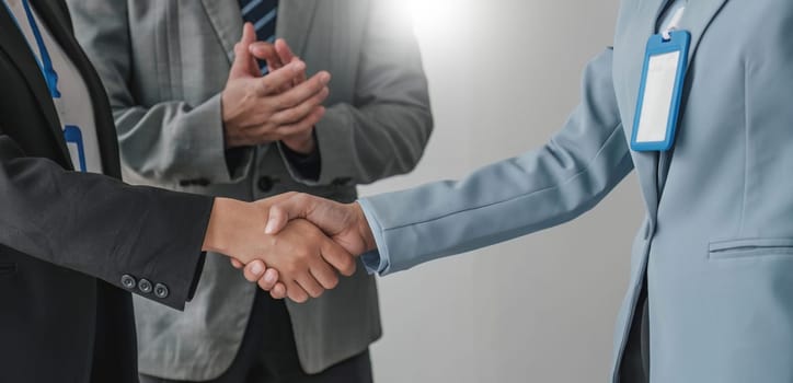 Business handshake for teamwork of business merger and acquisition,successful negotiate,hand shake,two businessman shake hand with partner to celebration partnership and business deal concept...