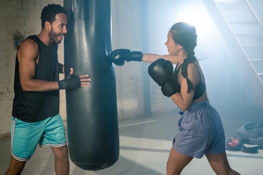 Fit and Strong Multicultural Couple Practicing Boxing Together in the Gym, Promoting Health and Unit. Real people sport concept. High quality photo