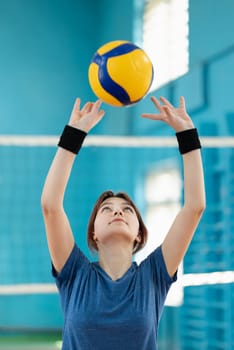 Girl masters skills of passing and setting the volleyball