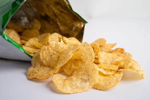 Potato chips, delicious spicy for crips, thin slice deep fried snack fast food in open bag.