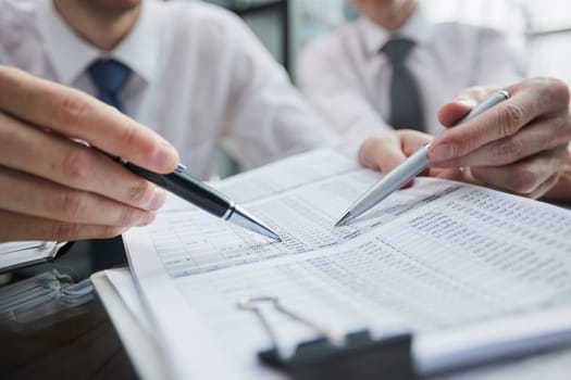 man hands with pen writing on notebook in the office.learning, education and work