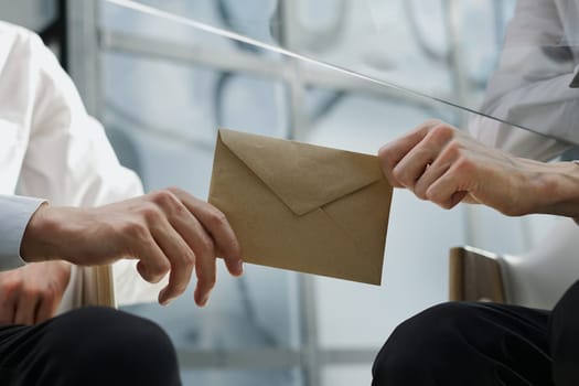 Transfer of money in an envelope in men