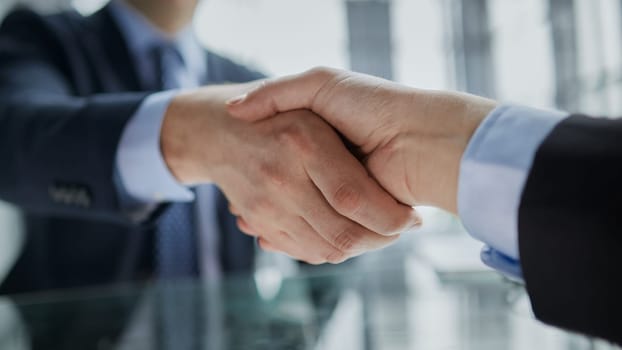 Real estate broker agent Shake hands after customer signing contract document for ownership realty purchase in the office, Business concept and signing contract