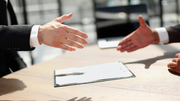 Successful business people handshaking after good deal.