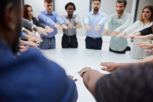 a group of young people stretched out their hands towards