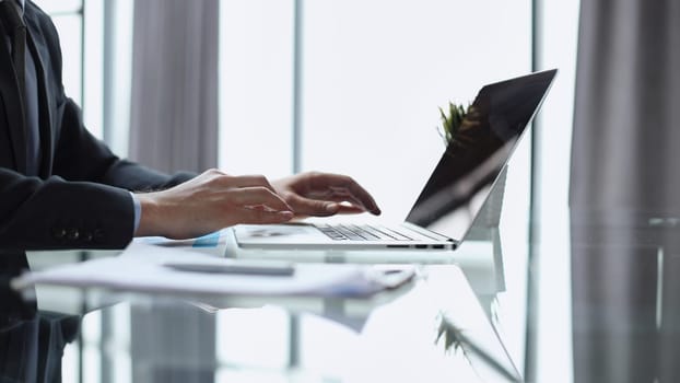 Close-up of male hands typing laptop keyboard. man using laptop