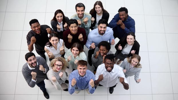 group of happy young business people looking up